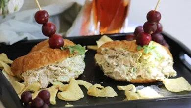 Tarragon chicken salad sandwiches on croissants with grape skewers, chips, and iced tea