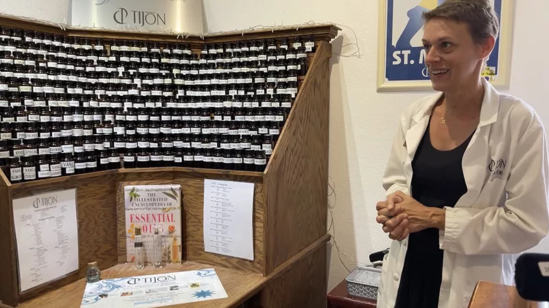 How to Create Your Own Custom Perfume in French St. Martin: A Complete Guide 4 Large wooden display case containing over 300 different fragrance oils and essences organized for custom perfume creation.