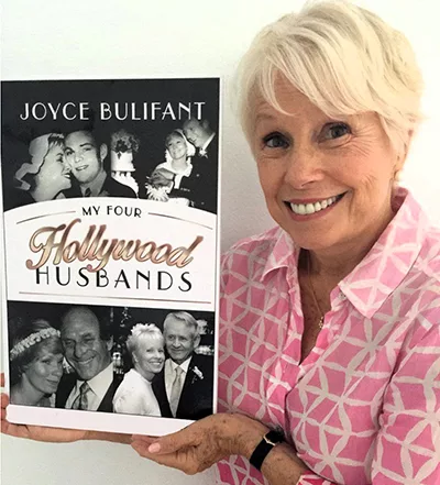Joyce Bulifant displaying cover of her book My Four Hollywood Husbands. Provided by publicist E W jpg