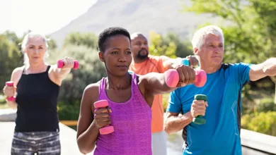 Staying Fit at 50+ 5 Women and men in their 50s exercising outdoors