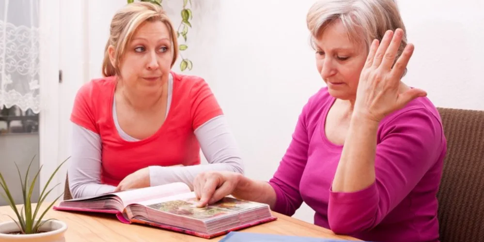 Daughter Trying to Trigger Parent’s Memory with Photos