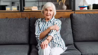 50+ woman sitting on a couch by herself