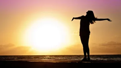 Woman on Pier Overlooking the Ocean at Sunrise