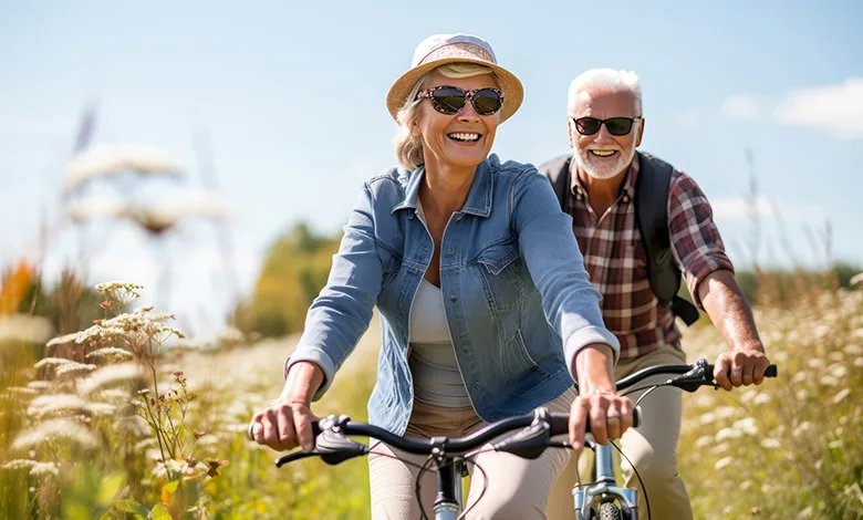 How to Boost Your Vitamin D Levels Naturally—All Year Long 1 Older couple cycling outdoors on a sunny day, staying active and supporting their vitamin D levels.