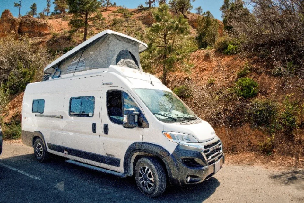 RV Travel After 50 4 A compact Class B RV with its pop-top raised, parked at Bryce Canyon National Park.