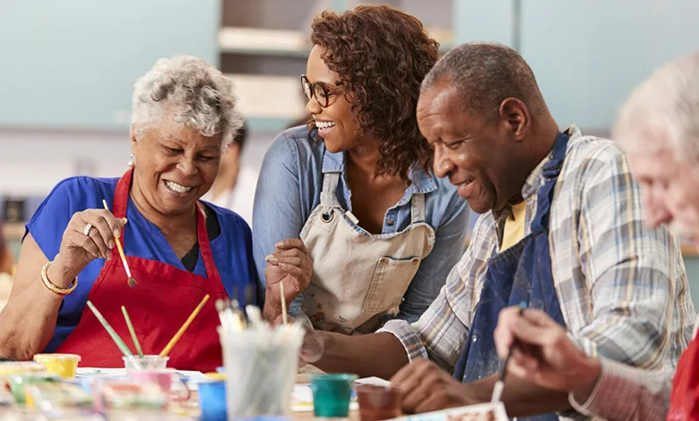5 Ways You Can Support Seniors in Your Local Community 1 Seniors participating in a community painting class, fostering creativity and social connection.