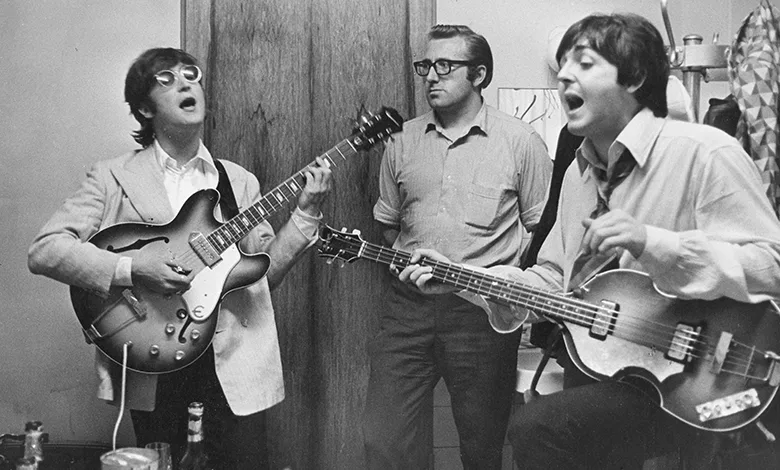 Living the Beatles Legend 1 John Lennon and Paul McCartney rehearse while Mal Evans observes in the studio.