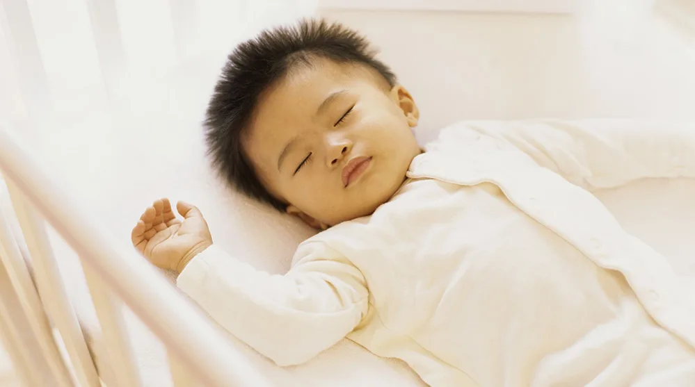 Are Grandparents the Answer to America's Childcare Crisis? 2 Infant sleeping safely on their back, following modern safe sleep recommendations.