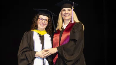 Cristina Flores-Villarreal, 58, on the right, in cap and gown, celebrates her graduation from Texas A&M College of Dentistry alongside Professor Maureen Brown.