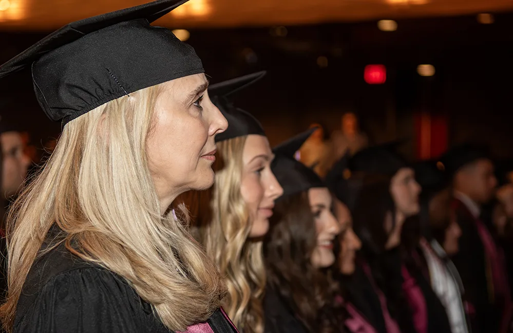 It’s Never Too Late: 58-Year-Old Mom Earns Her Degree 2 Cristina Flores-Villarreal and Macie Harris seated with her fellow dental hygiene graduates at Texas A&M College of Dentistry.