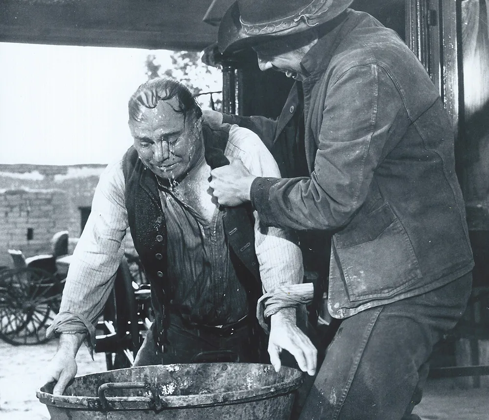 John Doucette: The Character Actor Who Stole Every Scene 2 John Doucette in his role as Hyselman, the undertaker, being roughed up in a scene from The Sons of Katie Elder(1965).