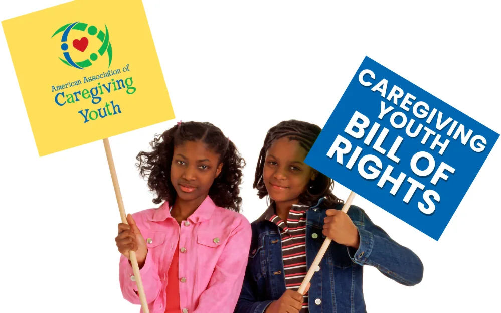 Grandparents Raising Grandchildren 3 Two children holding handmade signs about the American Association of Caregiving Youth and the Caregiving Youth Bill of Rights.