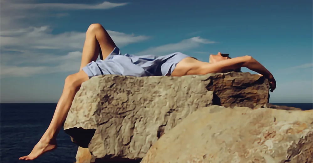 woman laying on rock resized 800 by maria lupan unsplash E W
