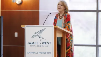 How Faith and Spirituality Help Families Navigate Dementia 4 Speaker presents at the James L. West Center for Dementia Care Annual Symposium to the audience in the conference room with large windows.