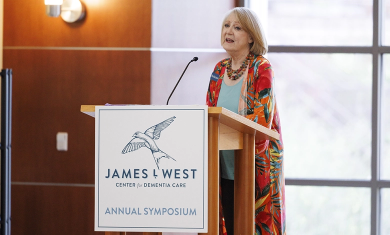 How Faith and Spirituality Help Families Navigate Dementia 1 Speaker presents at the James L. West Center for Dementia Care Annual Symposium to the audience in the conference room with large windows.