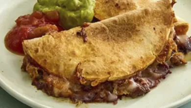 Let's Taco 'Bout it with Sheet Pan Tacos 24 Golden brown crispy sheet pan tacos on a white plate with guacamole and salsa, showing the finished result of the kid-friendly recipe.