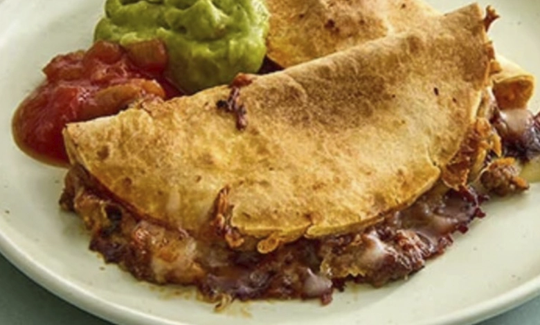 Let's Taco 'Bout it with Sheet Pan Tacos 1 Golden brown crispy sheet pan tacos on a white plate with guacamole and salsa, showing the finished result of the kid-friendly recipe.