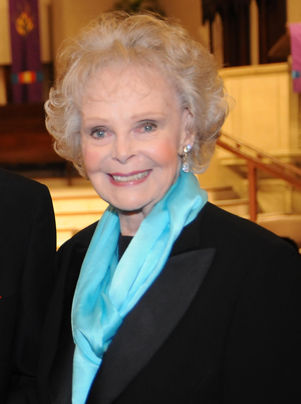 June Lockhart at 100 6 Recent photo of June Lockhart at 100 years old, wearing a black outfit with turquoise scarf, smiling at an event
