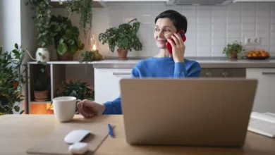 Setting Boundaries with Adult Children Without Damaging the Relationship 6 Woman having a calm phone conversation at home, demonstrating composure while setting boundaries