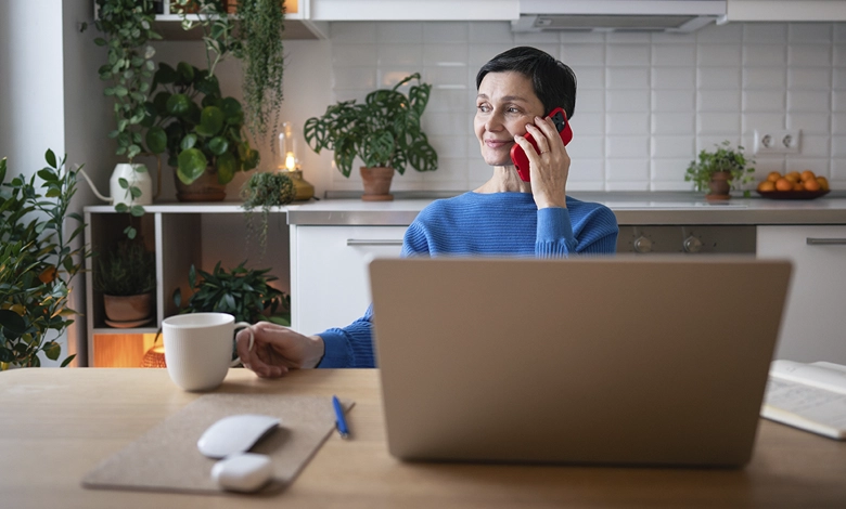 Setting Boundaries with Adult Children Without Damaging the Relationship 1 Woman having a calm phone conversation at home, demonstrating composure while setting boundaries