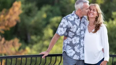 6 Secrets to Long-Term Relationships That Last After 50 8 Mature couple showing affection with man kissing woman's cheek outdoors, demonstrating long-term relationship intimacy.