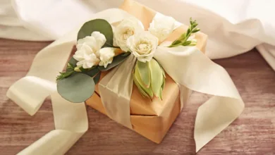 5 Thoughtful Wedding Gift Ideas That Go Beyond the Usual 2 Elegant gold wrapped wedding gift with white roses and ribbon
