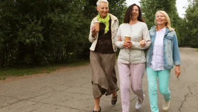 Two friends walking outdoors together, building friendships after 50 through shared activity