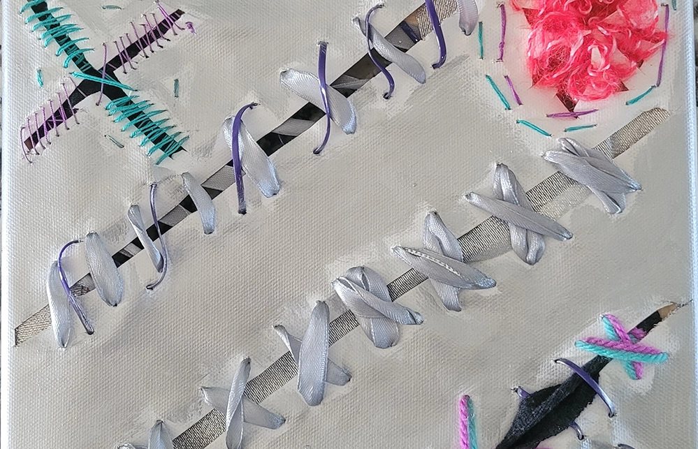 Breast Cancer Survivors Exhibition 4 White canvas with stitched ribbons and thread in purple, teal, and pink by Dallas artist Marissa Rusnow.