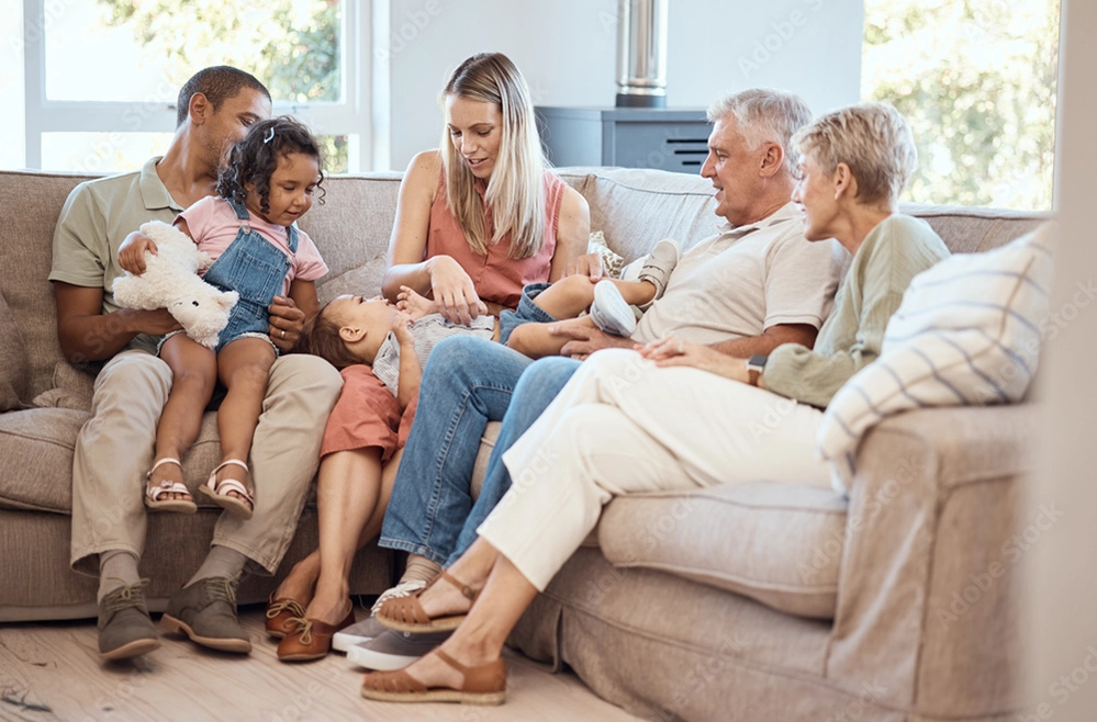 How to Create a Comfortable Home for Multigenerational Living 4 Three generations relaxing together on couch in multigenerational home showing family connection and companionship