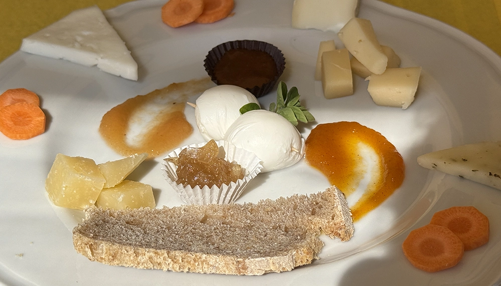 3 Hidden Culinary Gems in Tuscany 5 A beautifully arranged plate of cheese, pumpkin jam, and onion compote at Poggio di Camporbiano in Tuscany.