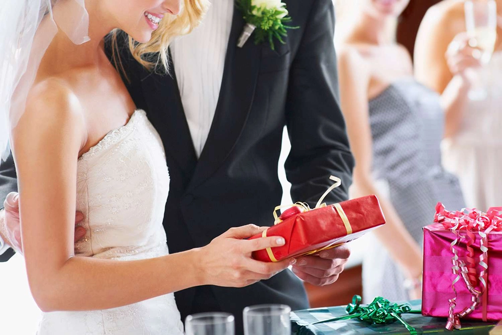 5 Thoughtful Wedding Gift Ideas That Go Beyond the Usual 5 Beautifully wrapped unique wedding gift with personalized tag and ribbon