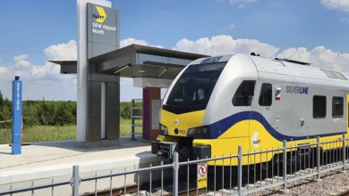 DART Silver Line train at DFW Airport North station platform with modern station canopy and blue sky