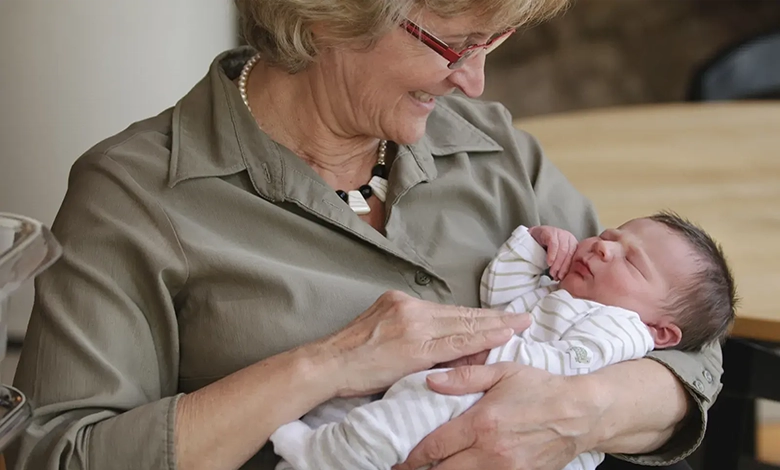 Grandmother lovingly holding newborn grandbaby demonstrating the bond between grandparents and grandchildren