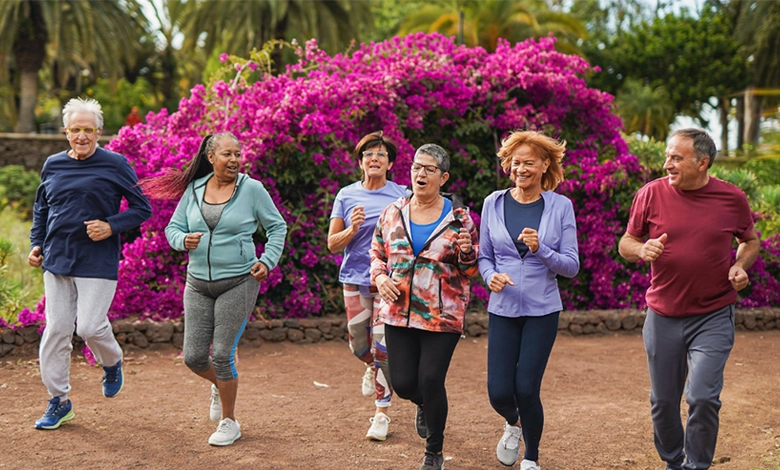 Diverse group of seniors jogging together in retirement community with beautiful landscaped grounds and vibrant flowers