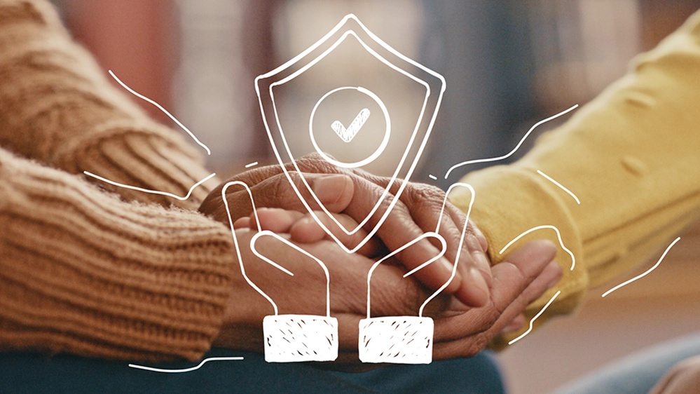 Elderly hands with illustrated security shield symbol representing digital fraud protection and online safety