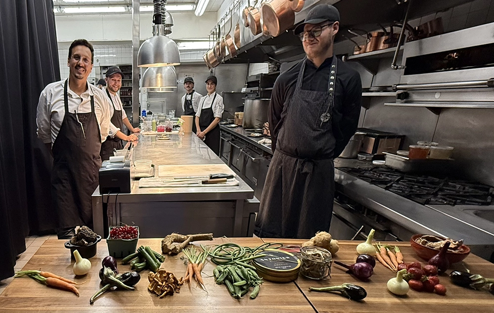 Chef Raphael Vezina and culinary team at Laurie Raphael restaurant in Quebec City with fresh local vegetables and ingredients