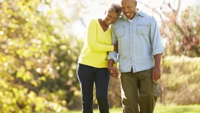 Couple walking together in park for mental health and well-being
