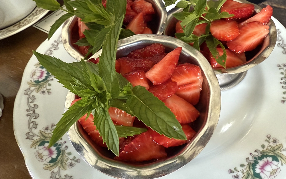 Silver cups filled with fresh strawberries and mint served at high tea on Île d’Orléans.