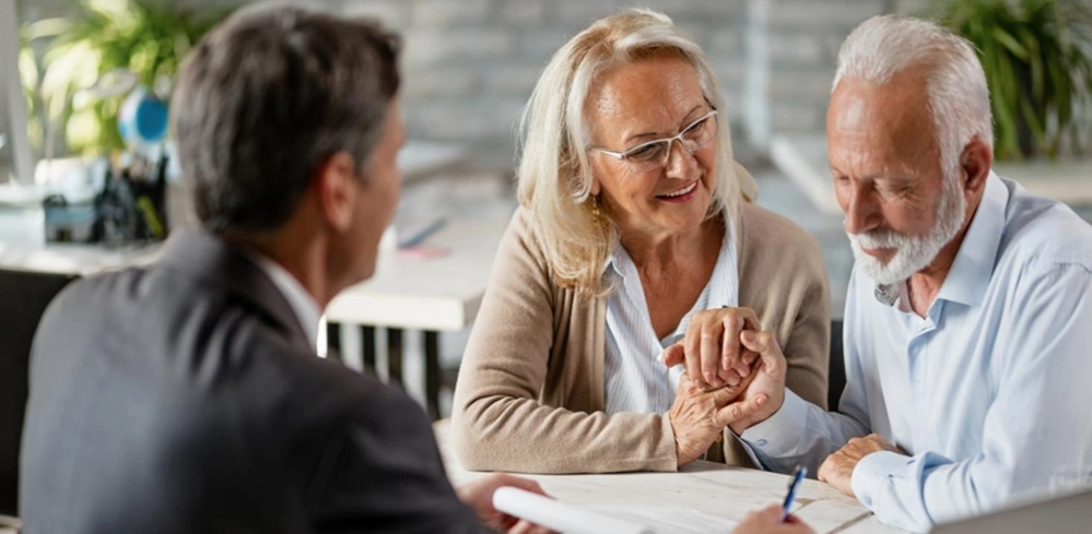 Classic dark green vintage car on a four-post lift in a wood-paneled garage