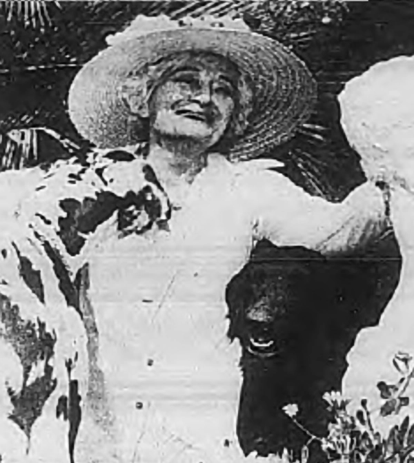 Dolores Costello in her Fallbrook garden with her dogs, 1975