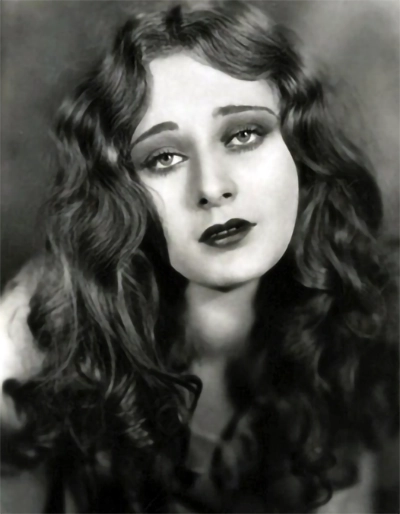 Dolores Costello in a glamour portrait with soft curls and dark lipstick, circa 1928