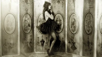 Dolores Costello posing as a Ziegfeld girl in a tutu against an ornate backdrop, 1923