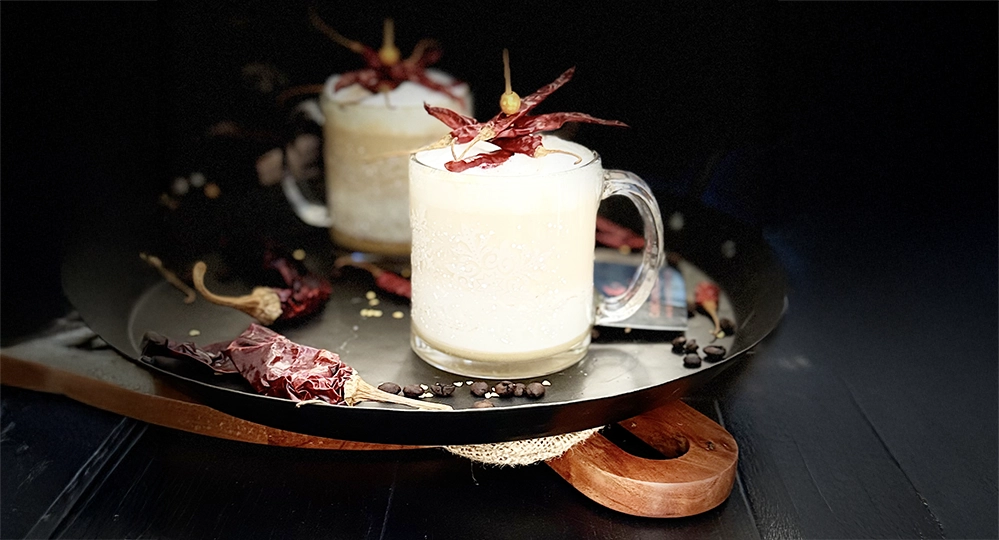 Fuego con Bourbon: A Spicy Bourbon Coffee Cocktail 2 Fuego con Bourbon coffee cocktail with frothed milk foam and dried Arbol chili garnish