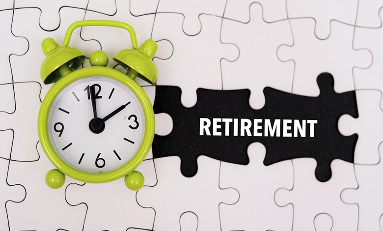 Alarm clock and puzzle pieces with the word retirement representing non-financial retirement planning