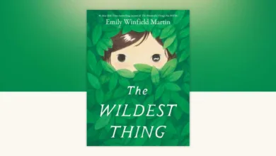 Book cover of The Wildest Thing by Emily Winfield Martin — a child's face peeking through green leaves