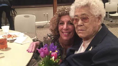 Grandmother Lee OkSeon holding a bouquet of purple and pink tulips during her Dallas visit