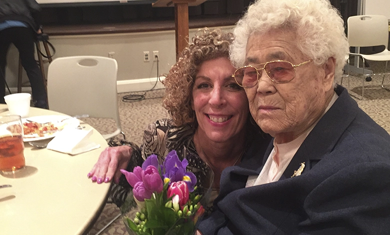Grandmother Lee OkSeon holding a bouquet of purple and pink tulips during her Dallas visit