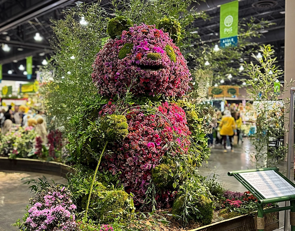 Floral bear sculpture made with orchids and mixed flowers at the Philadelphia Flower Show
