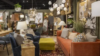 "Beautifully styled designer room vignette by Living Luxury Lab by MxD Interiors at The STUDIO Dallas featuring an orange velvet sofa, blue armchairs, layered lighting and one-of-a-kind décor"