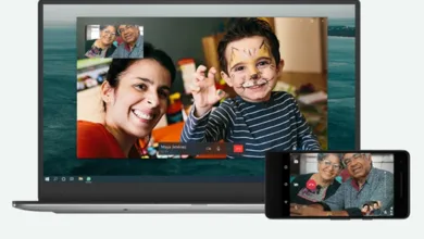 Grandparents video chatting with family using WhatsApp on a laptop and smartphone